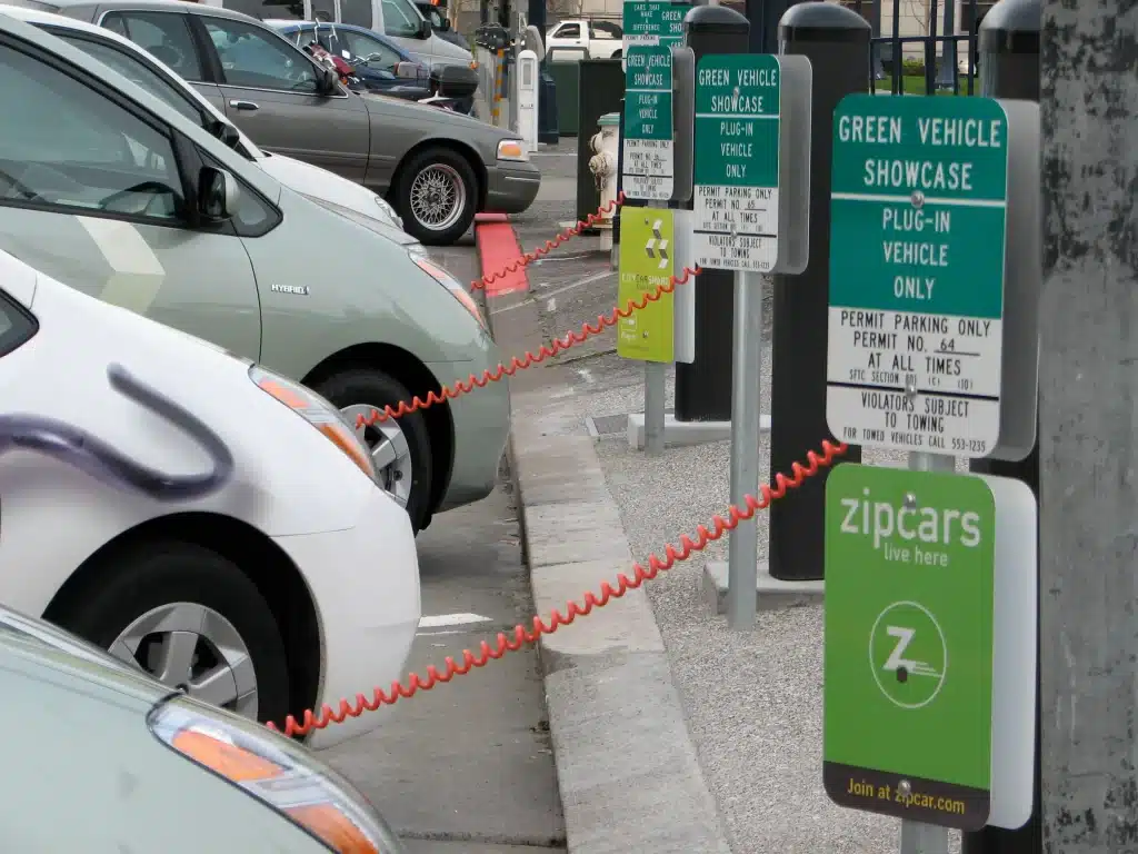 Car park with EV charging point of gas station and traffic sign