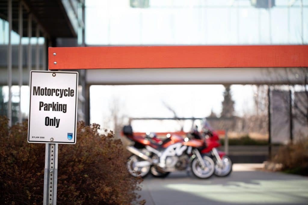 Motorcycle parking at the office sign