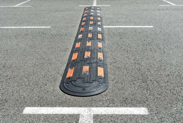 Speed hump on an asphalt. Traffic management and car driving
